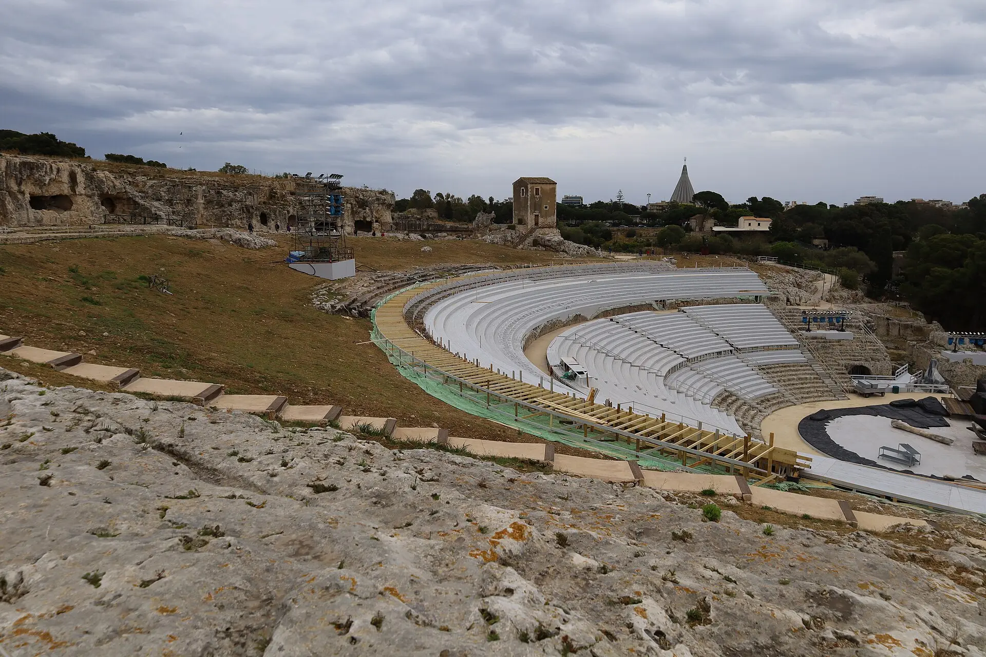 The Greek theatre of Syracuse, its semicircular tiers cut directly into the hillside
